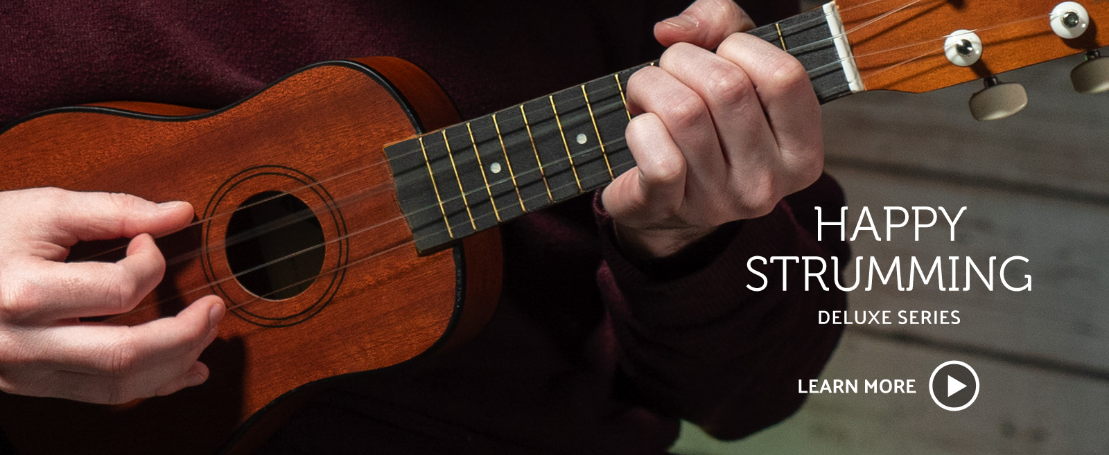 closeup of man's hands playing ukulele