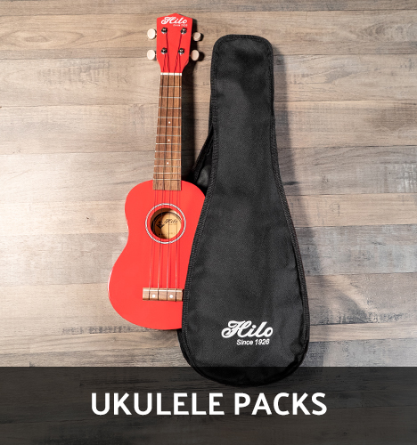 front view of red Hilo ukulele beside black gig bag